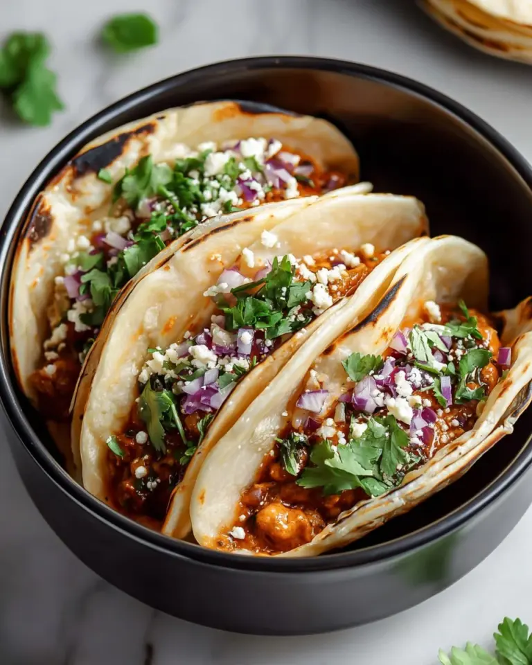 Delicious Asian chicken wonton tacos on a plate garnished with fresh vegetables