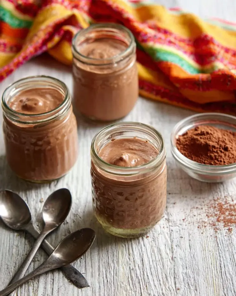 Delicious chocolate chia pudding topped with fresh berries and mint leaves.