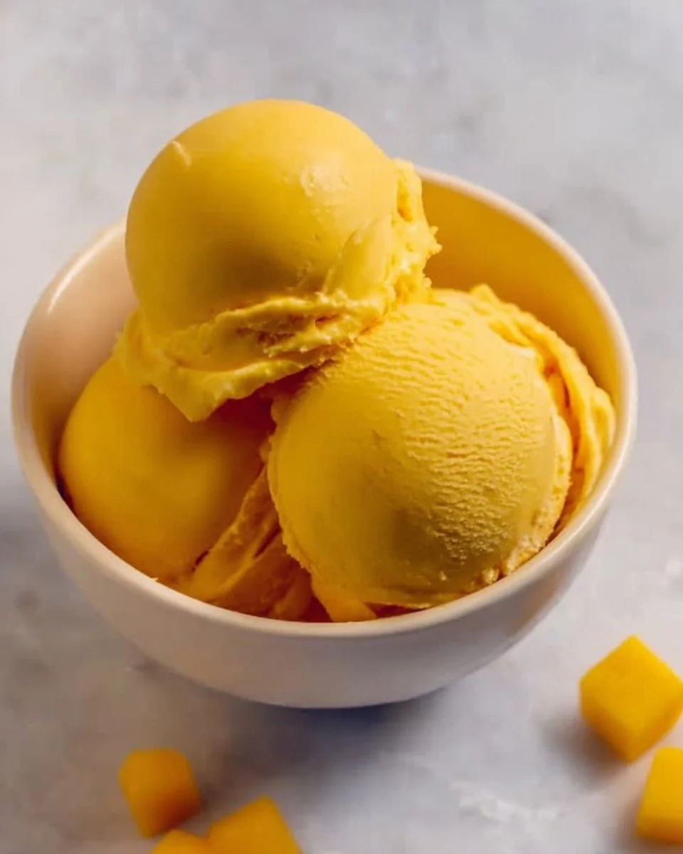 Easy homemade mango ice cream with fresh mango slices and a creamy texture