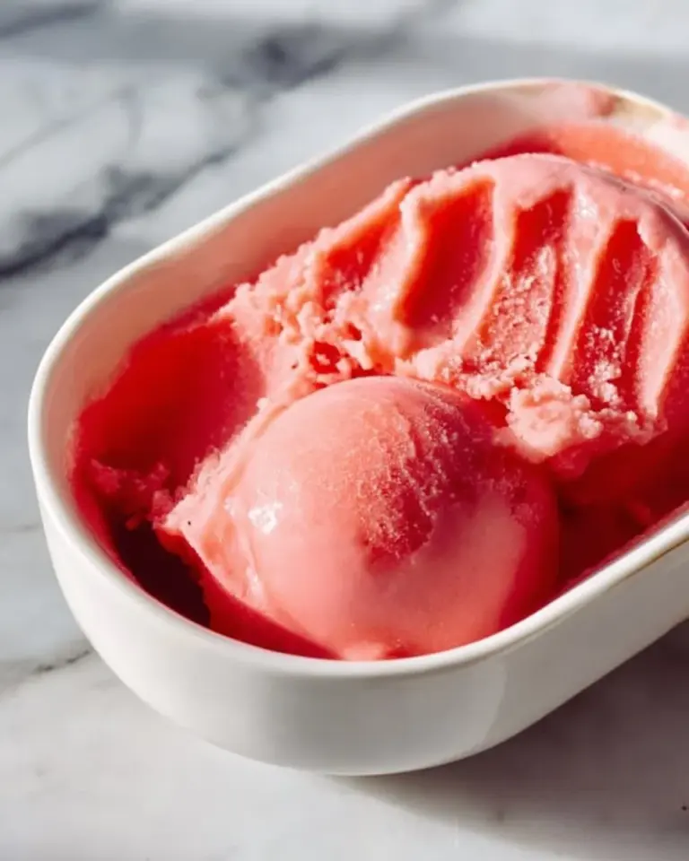 Delicious Watermelon Sorbet served in a bowl with fresh watermelon slices.