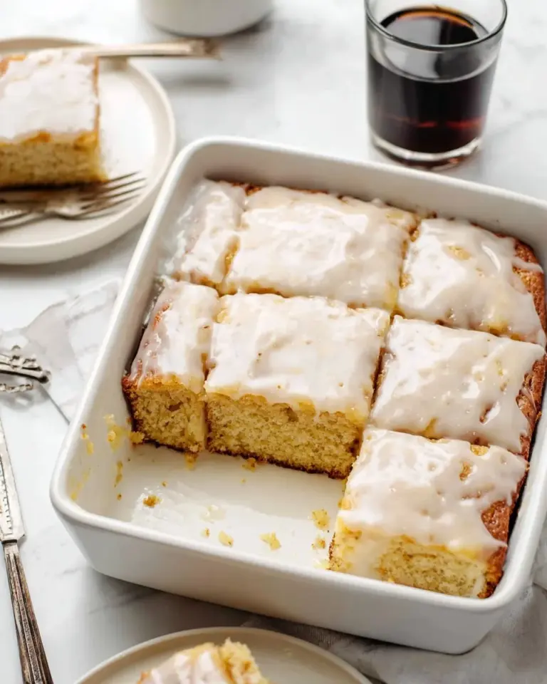 Delicious homemade Honey Bun Cake on a plate with a fork.