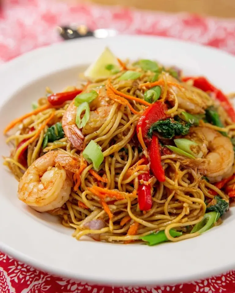 Delectable Pancit Canton - Filipino egg noodle stir fry with vibrant veggies and flavors.