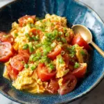 Savory scrambled eggs with fresh tomatoes on a plate